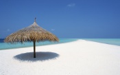 Maldives, Beach Umbrella And Placid White Beach